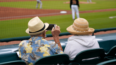 Baseball fans watch a spring training exhibition baseball game between the Pittsburgh Pirates and the Baltimore Orioles in Bradenton, Fla., March 22, 2021.