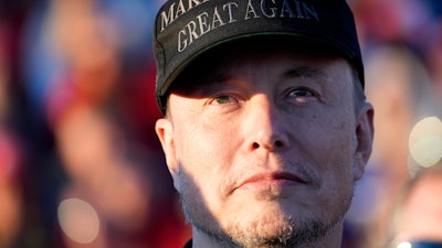 Tesla and SpaceX CEO Elon Musk listens as President Donald Trump speaks at a campaign event at the Butler Farm Show, Oct. 5, 2024, in Butler, Pa.