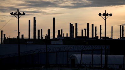 The plant is silhouetted by the early morning light at the Stellantis Toledo Assembly Complex on Oct. 26, 2023, in Toledo, Ohio.