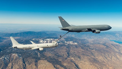 The KC-46A Tanker refueling another plane in midair.