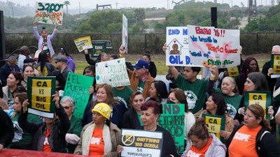 Members of Campaign for a Safe and Healthy California coalition campaign for Keep The Law (SB 1137) next to the Inglewood Oil Field in Inglewood, Calif., March. 22, 2024.