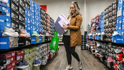 Ashley Crafton looks at tennis shoes at at Shoe Stop while shopping during Small Business Saturday in Wesleyan Park Plaza on Nov. 25, 2023, in Owensboro, Ky.