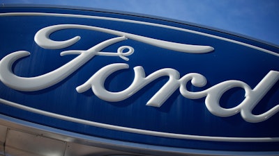 The Ford company logo is seen, Oct. 24, 2021, on a sign at a Ford dealership in southeast Denver.