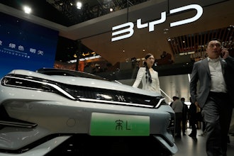 A model poses near the BYD Song L EV car during Auto China 2024 held in Beijing, April 25, 2024.