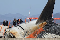 Experts from the U.S. National Transportation Safety Board (NTSB) and joint investigation team between the U.S. and South Korea check the site of a plane crash at Muan International Airport in Muan, South Korea, Tuesday, Dec. 31, 2024.