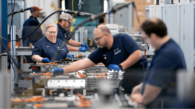 Employees work in the battery assembly hall at the BMW Spartanburg plant in Greer, S.C. on Oct. 19, 2022.