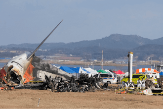 Rescue team members work at the site of a plane fire at Muan International Airport in Muan, South Korea, Monday, Dec. 30, 2024.