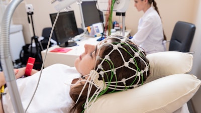 Patient brain testing using encephalography at medical center, used in sleep studies.