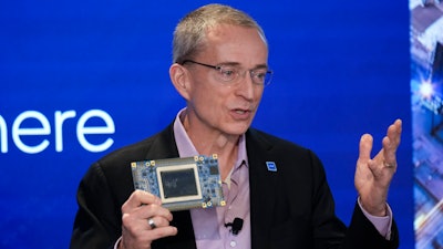 Intel CEO Pat Gelsinger speaks while holding a new chip, called Gaudi 3, during an event called AI Everywhere in New York, on Dec. 14, 2023.