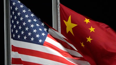 The American and Chinese flags wave at Genting Snow Park ahead of the 2022 Winter Olympics, Feb. 2, 2022, in Zhangjiakou, China.