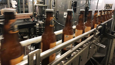 Bottles freshly filled with beer move on a conveyor belt at Lakefront Brewery in Milwaukee, Jan. 14, 2019.