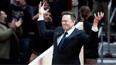 Elon Musk arrives on stage to speak at an indoor Presidential Inauguration parade event in Washington, Monday, Jan. 20, 2025.