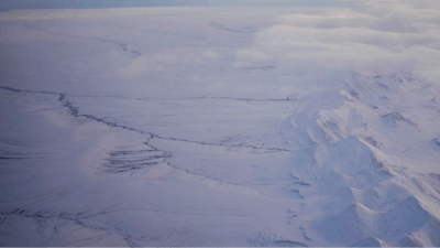 The snow-covered coastal plain area of the Arctic National Wildlife Refuge is seen, with the Brooks Range at right, Monday, Oct. 14, 2024, near Kaktovik, Alaska.