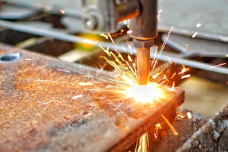 A machine cutting through thick steel with high temperature application.