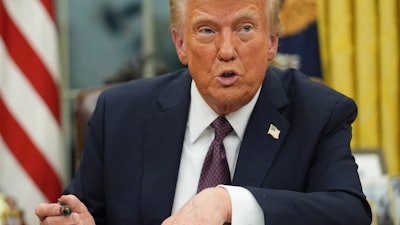 President Donald Trump talks as he signs executive orders in the Oval Office of the White House, Monday, Jan. 20, 2025, in Washington.