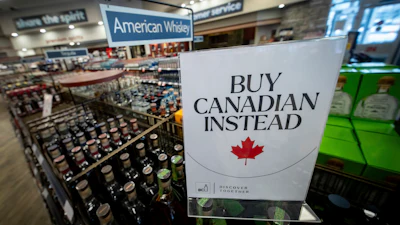 A sign is placed in front of the American whiskey section at a B.C. liquor store after top selling American made products have been removed from shelves in Vancouver, B.C., Sunday, Feb. 2, 2025.
