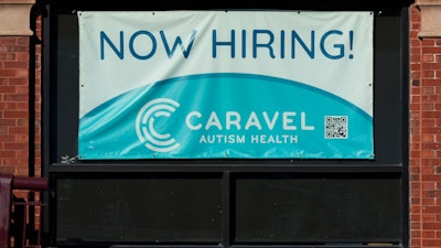 Hiring sign is displayed at a health service center in Chicago, Tuesday, Jan. 21, 2025.