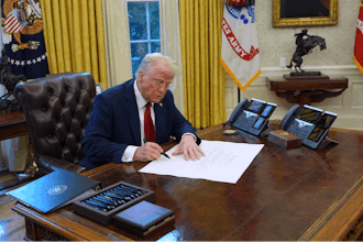 President Donald Trump signs executive orders in the Oval Office at the White House, Thursday, Jan. 30, 2025, in Washington.