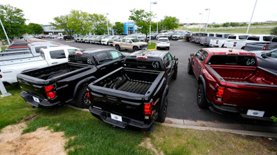 Unsold 2024 Colorado and Silverado pickup trucks sit in rows outside a Chevrolet dealership Sunday, June 2, 2024, in Lone Tree, Colo.