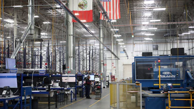 National flags representing the United States and Mexico hang inside in a textile factory that produces T-shirts, in Ciudad Juarez, Mexico, Tuesday, Feb. 4, 2025.