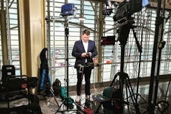This April 2023 image released by CNN shows aviation correspondent Pete Muntean preparing for a live broadcast at Reagan National Airport in Washington.