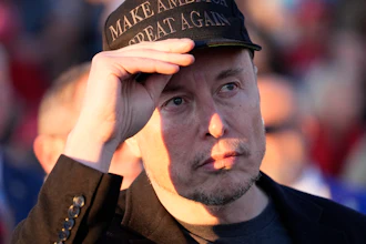 Elon Musk listens as Republican presidential nominee former President Donald Trump speaks at a campaign event at the Butler Farm Show on Oct. 5, 2024, in Butler, Pa.