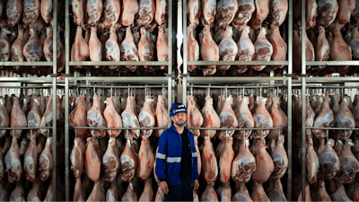 Víctor Razuri, 41, from Peru, poses in a ham drying plant in Guissona, Lleida, Spain, Feb. 20, 2025.