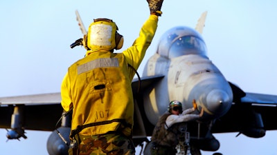 A naval plane on an aircraft carrier. The Navy uses 3D printed parts to keep planes flying and can turn around repairs faster because of the speed of 3D printing.