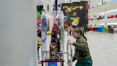 Brentley Joyce, 8, uses a penny press machine at the American Dream mall, Sunday, March 2, 2025, in East Rutherford, N.J.