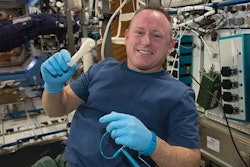 NASA astronaut Barry Wilmore holds a 3D-printed wrench made aboard the International Space Station.