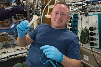 NASA astronaut Barry Wilmore holds a 3D-printed wrench made aboard the International Space Station.