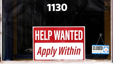 A help wanted sign is seen at a Allstate insurance office in Elgin, Ill., Saturday, March 19, 2022.
