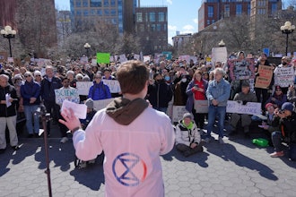 People listen to Griffin Gowdy, a PhD student at Columbia University, speak during a 'Stand Up for Science' rally in New York, Friday, March 7, 2025.