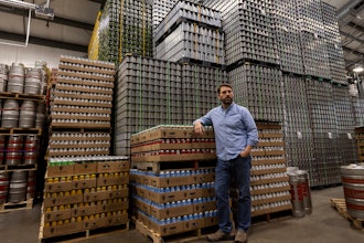 Jeff Ware, president of Resurgence Brewing Company, poses for a portrait near a stockpile of aluminum cans, which are sourced from Canada, Thursday, Feb. 27, 2025, in Buffalo, N.Y.