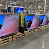 A shopper passes by a display of large-screen televisions in a Costco warehouse Monday, Feb. 3, 2025, in east Denver.