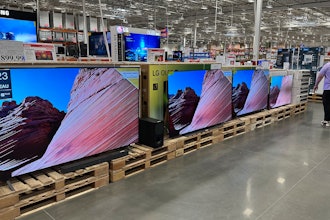 A shopper passes by a display of large-screen televisions in a Costco warehouse Monday, Feb. 3, 2025, in east Denver.