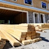 Lumber is piled at a housing construction site, June 24, 2021, Middleton, Mass.