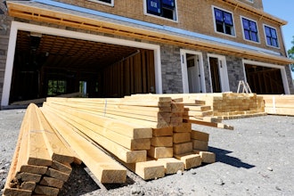 Lumber is piled at a housing construction site, June 24, 2021, Middleton, Mass.
