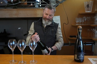 French wine grower David Levasseur opens a bottle of champagne in his wine making facility in Cuchery, eastern France, Monday, March 17, 2025.
