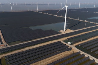 Wind turbines dot the coast line along a giant solar farm near Weifang in eastern China's Shandong province on March 22, 2024.