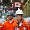 Canadian Prime Minister designate Mark Carney, second right, speaks to steel workers after touring the ArcelorMittal Dofasco steel plant in Hamilton, Ont., on Wednesday, March 12, 2025.