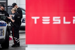 Officers from Ottawa Police Service (OPS) are seen at a Tesla Service and Showroom center after it was damaged with pink spray paint in Ottawa, on Monday, March 31, 2025.