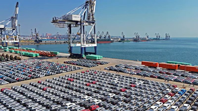 An aerial view of new cars waiting for shipment at a pier for ro-ro ships in Yantai city in eastern China's Shandong province Sunday, March 30, 2025.
