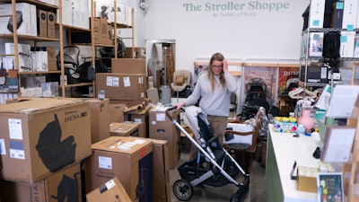 Elizabeth Mahon, owner of baby store Three Littles, unpacks strollers and other inventory ordered by customers ahead of tariff-driven price increases at her Union Market location in Washington, on Wednesday, April 16, 2025.