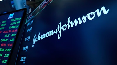 The Johnson & Johnson logo appears above a trading post on the floor of the New York Stock Exchange, Monday, July 12, 2021.