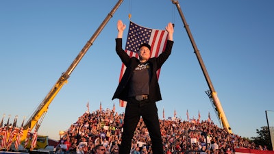 Tesla and SpaceX CEO Elon Musk walks to the stage to speak at the Butler Farm Show, Oct. 5, 2024, in Butler, Pa.