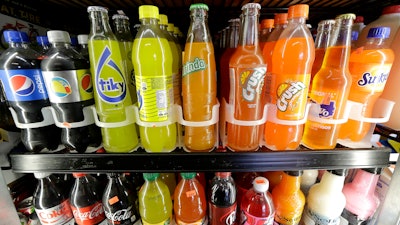 Soft drink and soda bottles are on display in a refrigerator at El Ahorro market in San Francisco, Sept. 21, 2016.