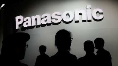 People walk by the Panasonic booth during CES International in Las Vegas on Jan. 9, 2018.