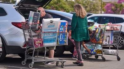 People pack items into their vehicles at Costco store in Burbank, Calif., April 10, 2025.