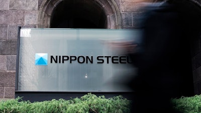 A person walks past a Nippon Steel Corporation sign at the company headquarters on Jan. 7, 2025, in Tokyo.